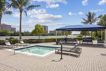 Lakeside pool with jacuzzi, sun deck and private cabanas